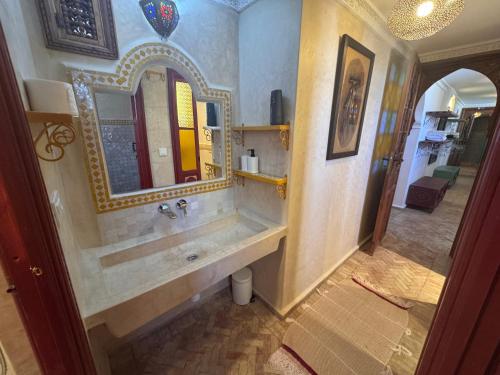 a bathroom with a sink and a mirror at Riad Al-Qurtubi in Tangier