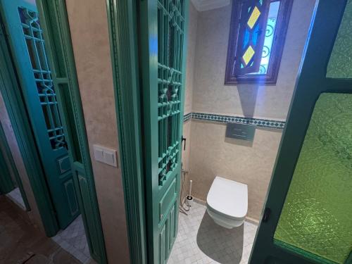 a bathroom with a toilet and a stained glass window at Riad Al-Qurtubi in Tangier