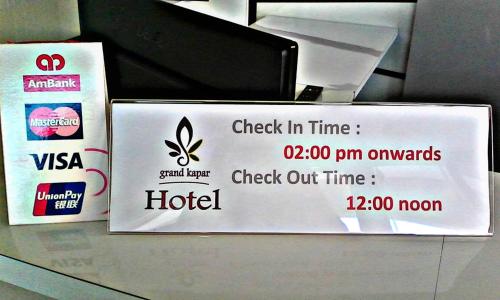 a sign for a hotel on a desk at Grand Kapar Hotel Kuala Selangor in Kuala Selangor