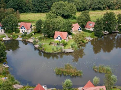 an aerial view of a home on a lake at Timmerholt Vakantiehuis 177 in Westerbork
