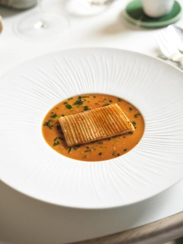 a white plate with a piece of food on it at L'Hôtel & Spa du Castellet in Le Castellet