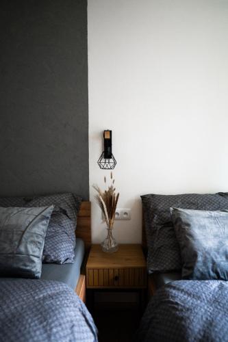 a bedroom with two beds and a vase of flowers on a table at Apartmán BeVi in Loučná nad Desnou