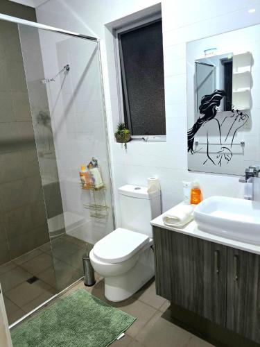 a bathroom with a toilet and a sink and a shower at Stylish 2-Bedroom Apartment in Maddington, 15 Minutes from Perth Airport in Perth