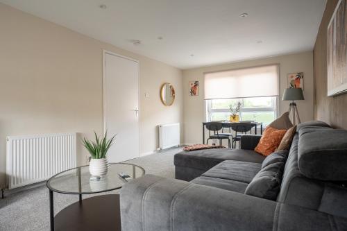 a living room with a couch and a table at Rise House in Livingston