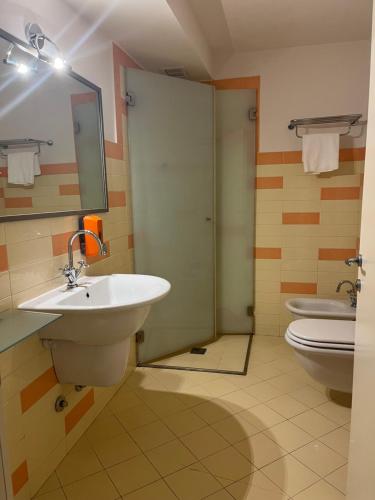 a bathroom with a sink and a toilet at Hotel Villa Costanza in Pontenure
