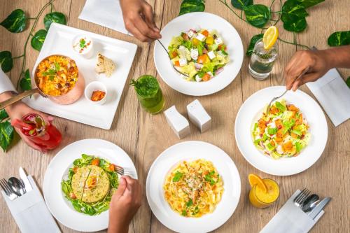 a group of people eating food on a table at JA The Manor Hotel, Dubai in Dubai