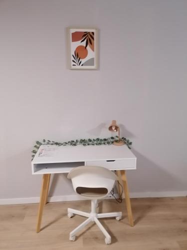 a desk with a chair and a white desk with a keyboard at Rent and Relax Geel in Geel