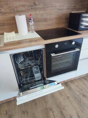 an oven with its door open in a kitchen at DOBA - LUKS клас 3-4 міс Завжди тепла ! in Mukacheve