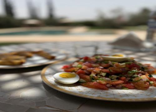 a plate of food with eggs on a table at Palais Menzah & SPA in Marrakech
