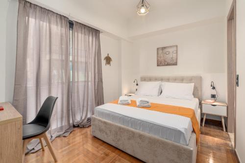 a bedroom with a bed and a desk and a chair at Athens Meli in Athens