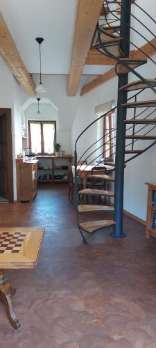 a room with a metal spiral staircase in a building at Vrba apartmán in Kájov