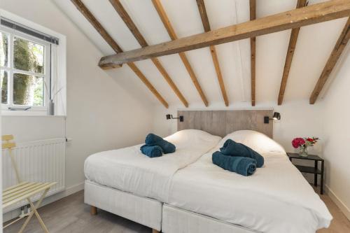 Ένα ή περισσότερα κρεβάτια σε δωμάτιο στο Boerderijwoning 't Trogje