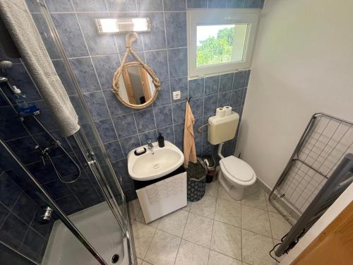 a bathroom with a sink and a toilet at LídRind porta in Zalaszentgrót