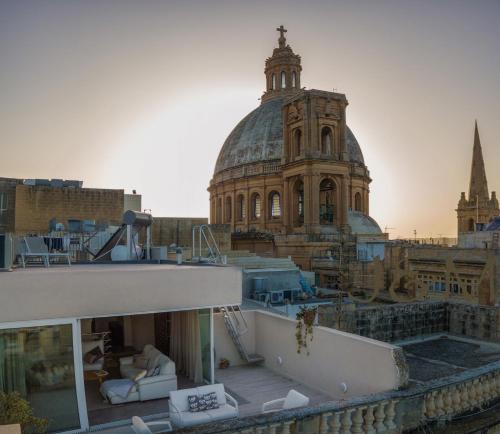 a view of a building with a clock tower at Palatial Flat inside Bright Duplex Penthouse in Valletta