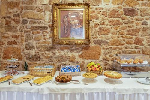 a table with cookies and other food on it at Hotel Fertilia in Fertilia