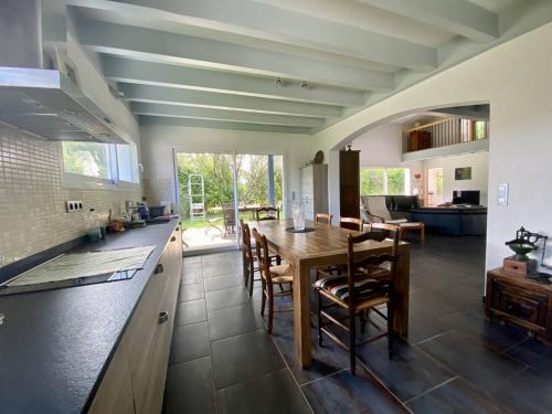 une cuisine et une salle à manger avec une table et des chaises dans l'établissement Bidart : Grande maison 4 chambres proche plages, 8 pers, au calme - FR-1-495-151, à Bidart