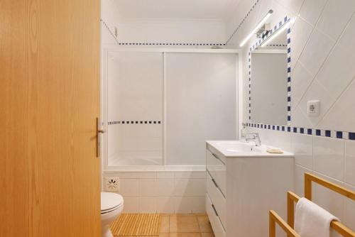 a bathroom with a toilet and a sink and a shower at Quinta Gomeira 59 in Tavira