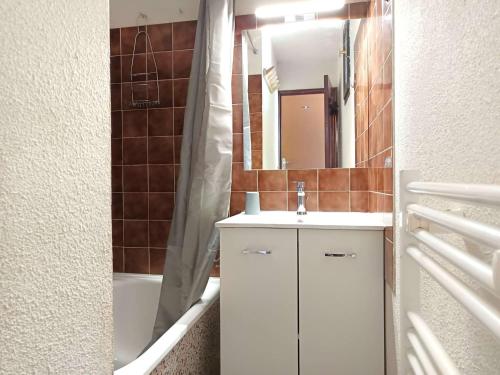 a bathroom with a sink and a mirror and a tub at T3 Duplex 6 Pers, Parking, Cuisine Équipée, Proche St Lary - FR-1-457-283 in Vielle-Aure