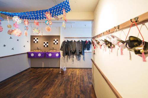 a room with clothes hanging on the wall at Tokyo Ninja 屋敷 in Tokyo
