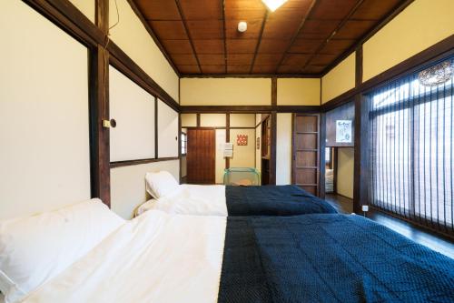 a bedroom with a bed and a large window at Tokyo Ninja 屋敷 in Tokyo