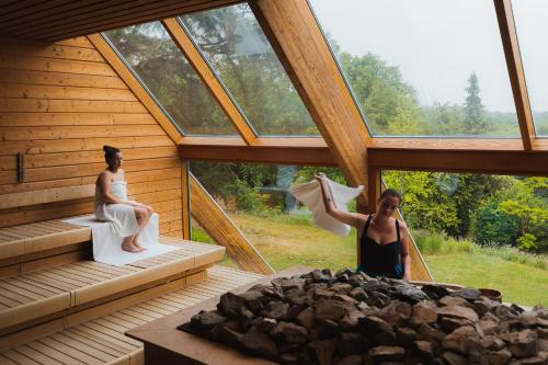 two women are standing in a room in a building at Wellnesshotel Thermae 2000 in Valkenburg