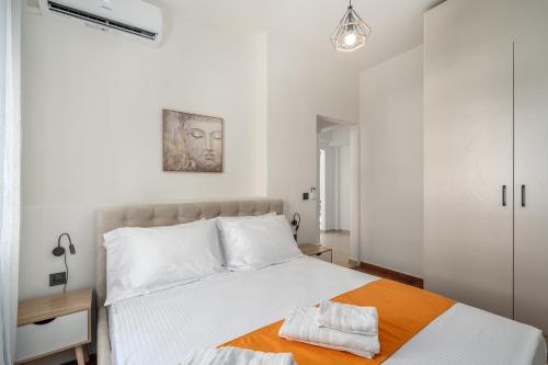 a bedroom with a large white bed with white pillows at Athens Meli in Athens