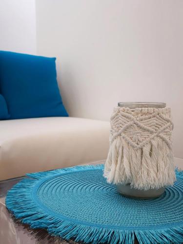 a blue rug on a table next to a couch at Hotel Bellariva in Lido di Jesolo