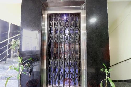a room with a door with a bunch of wine glasses at FabHotel Galaxy Suites I in Hyderabad