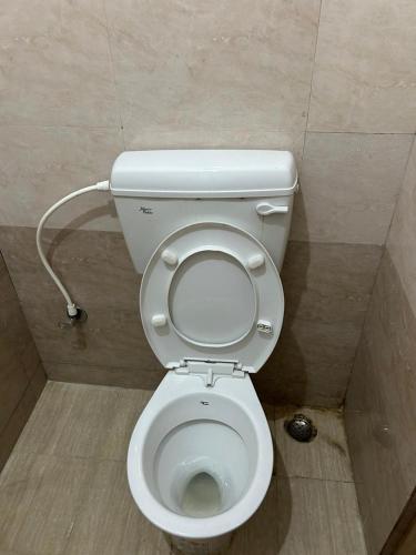 a bathroom with a toilet in a stall at Sri Lingaraja Temple Stay Budget Rooms & Dormitory in Old Town in Bhubaneshwar
