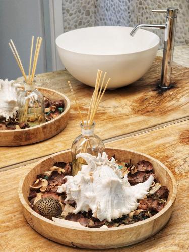 a wooden counter with two bowls and a sink at Hotel Bellariva in Lido di Jesolo