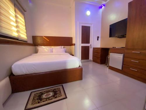 a bedroom with a large bed and a flat screen tv at Luxury Palace 