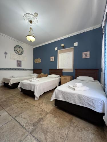 two beds in a room with blue walls at Casa Roma Boutique Hotel in Bodrum City