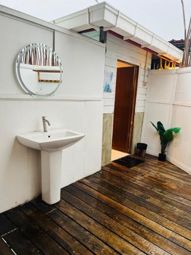 a bathroom with a sink and a mirror at Seaweed Village Deluxe Room in Semporna