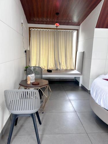 a room with a table and a bed and a window at CASA SIGN PRIVATE POOL VILLa in Meppādi