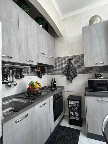 a kitchen with a sink and a stove top oven at Loft NUOVO vicino al centro - OASI Relax in Turin
