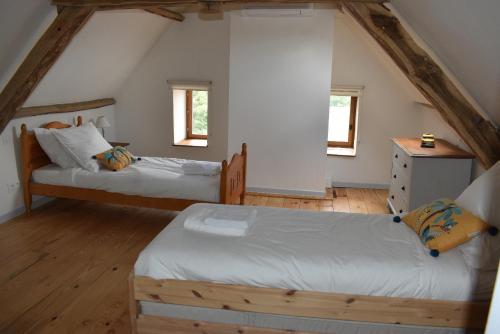 - une chambre mansardée avec 2 lits et 2 fenêtres dans l'établissement Les Granges, à Marquay