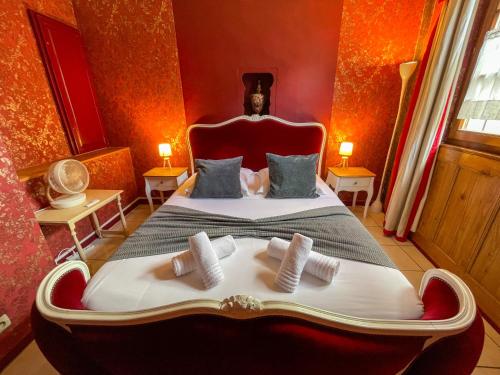 a bedroom with a large bed with two pillows at La Maison Bleue - Historic House in the Heart of Riquewihr in Riquewihr