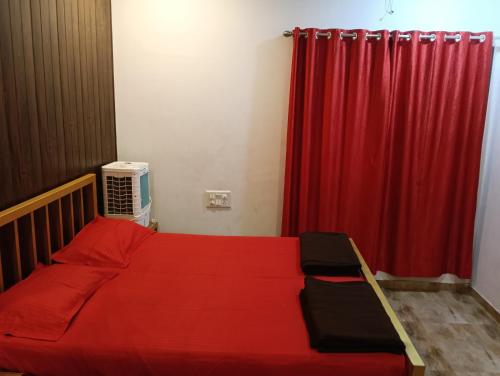 a bedroom with a red bed and a red curtain at Palmquist Villa in Neral