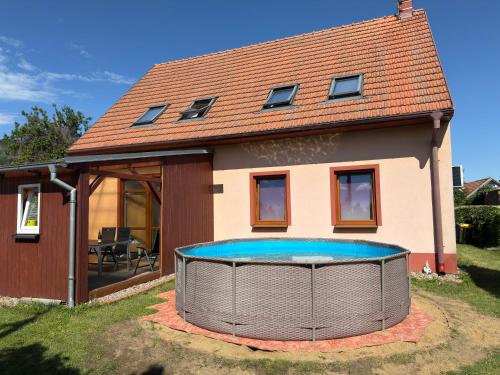 a house with a swimming pool in front of it at Pálava Chalupa in Pavlov
