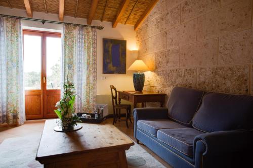 a living room with a couch and a table at Casal Santa Eulalia in Can Picafort