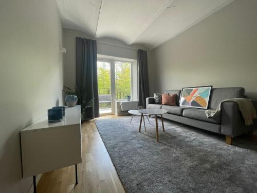a living room with a couch and a table at Mörrum River Residences in Mörrum