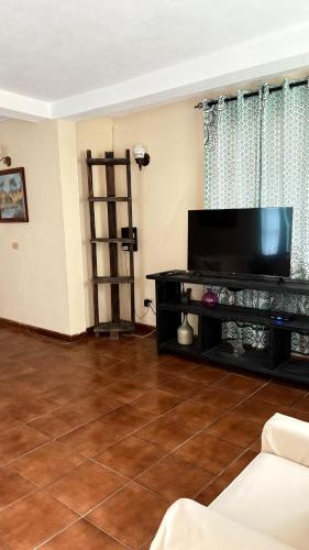 a living room with a large flat screen tv at Valley View in Saint George