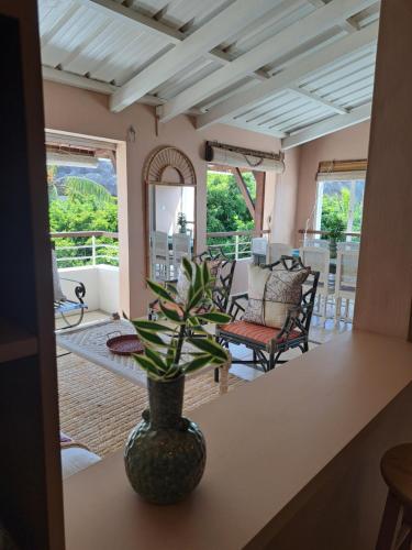 a vase sitting on a table in a living room at CosyNest Apartment in Cap Malheureux