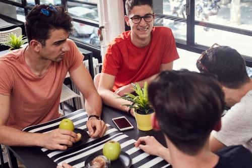 a group of people sitting around a table with apples on it at Free Hostels Barcelona in Barcelona