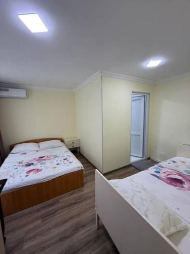 a hotel room with two beds and a hallway at Guest House at the park in Kutaisi
