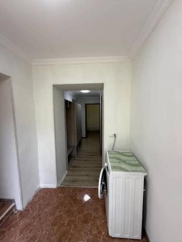an empty room with a hallway with a table at Guest House at the park in Kutaisi