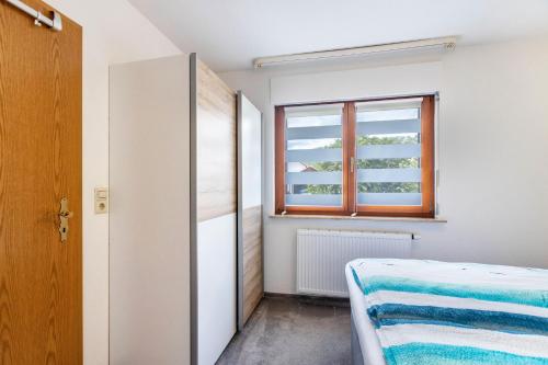 a small bedroom with a bed and a window at Ferienwohnung Rieth in Dürbheim
