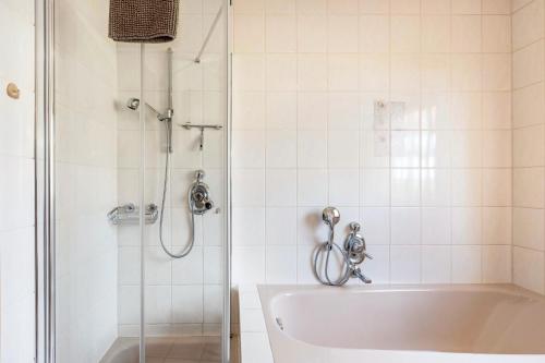 a bathroom with a shower and a white tub at Ferienwohnung Rieth in Dürbheim
