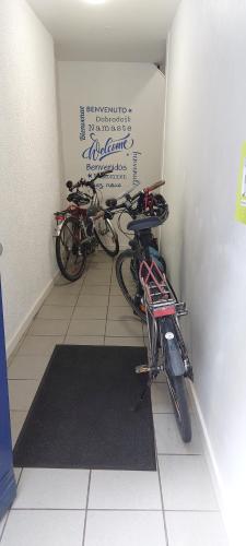 two bikes parked in a room with a wall at Le FOURNIRUE T2 in Metz
