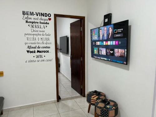 a sign on a wall with a television on a wall at BORA BORA RESIDENCE in Joinville